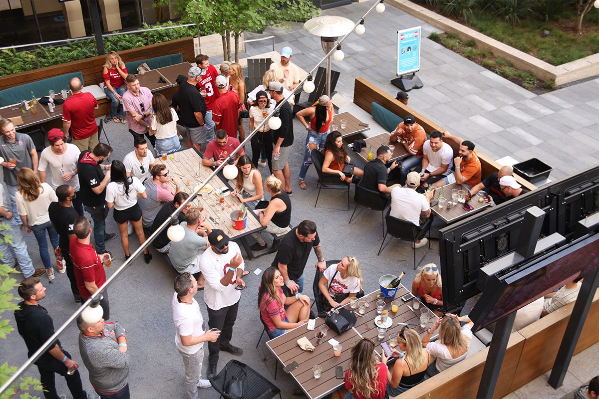 Crowd watching football on the Jaxon patio