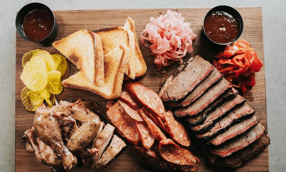 Texas BBQ board with brisket, sausage and pickles